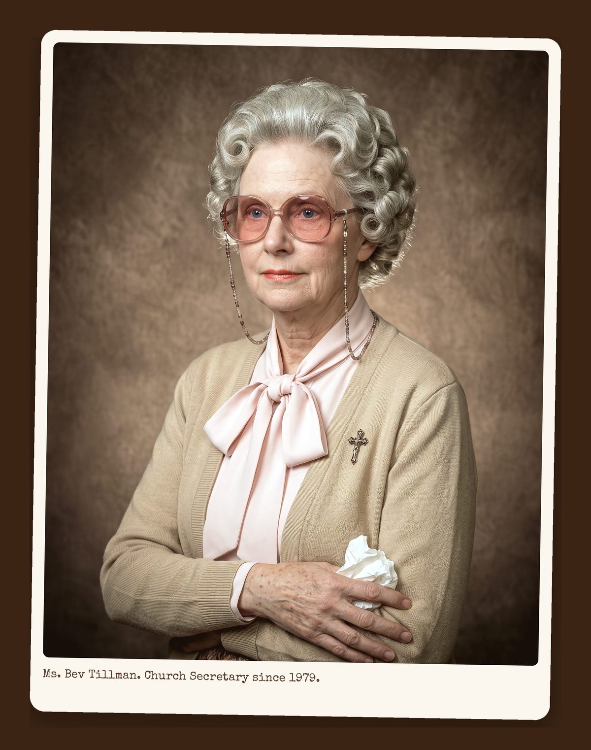 Ms. Bev Tillman, silver hair set, pink bow blouse and tan cardigan, holding a tissue, directory portrait.