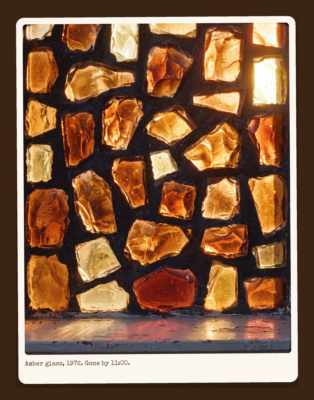 Close-up of amber and orange dalle-de-verre stained glass, thick chunks of glass set in dark mortar, lit from behind.